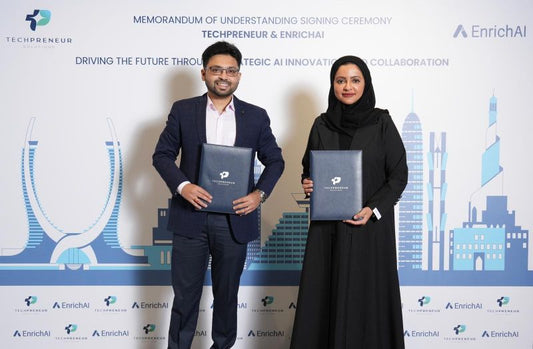 Representatives from TechPreneur and EnrichAI posing together with official documentation highlighting their new partnership.